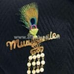 Mundewale brooch with peacock feather