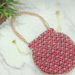 Cross embroidered potli with pearl handle